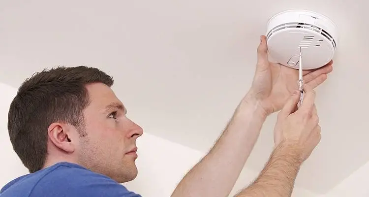 Image of contractor installing smoke alarm